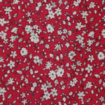 Tissu motif petites fleurs blanches sur fond rouge
